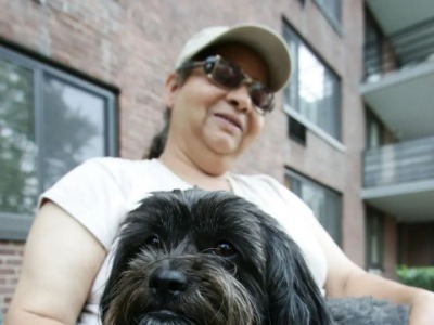 Bumpy Johnson's granddaughter, Margaret Johnson, holding her dog.